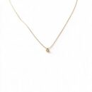 Dainty gold necklace with round crystal pendant worn around the neck